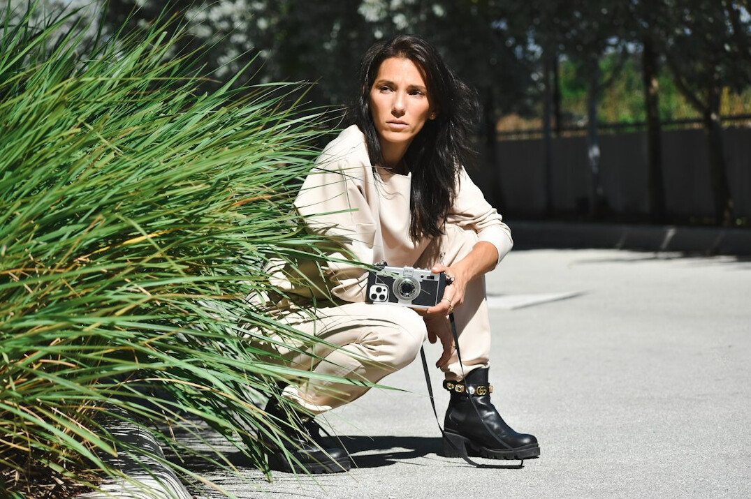 Portrait of a young Latina woman field reporter with a camera