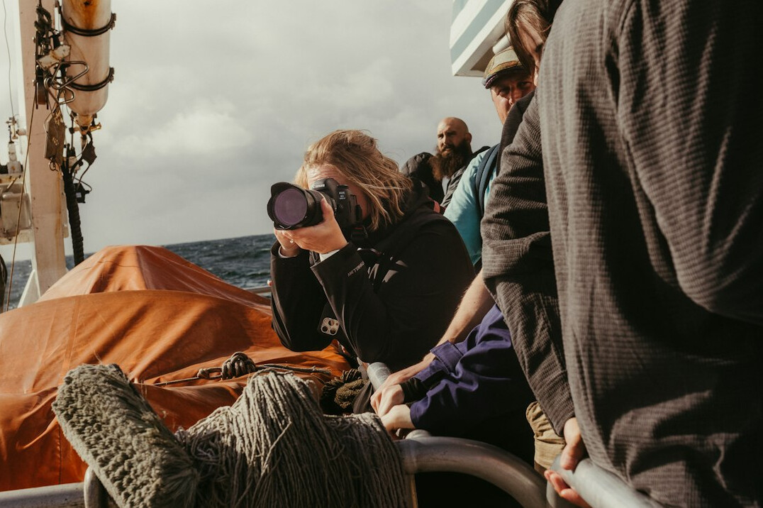 research team on boat with equipment