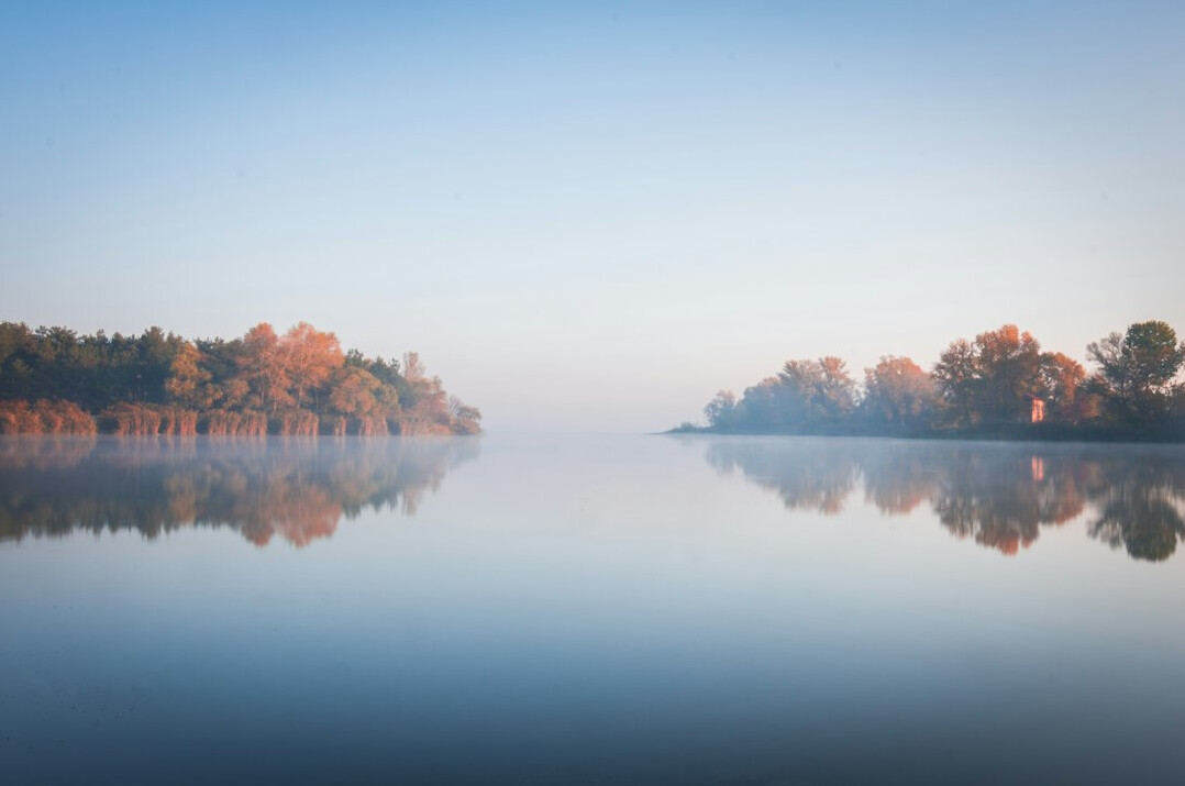 mysterious foggy lake at dawn