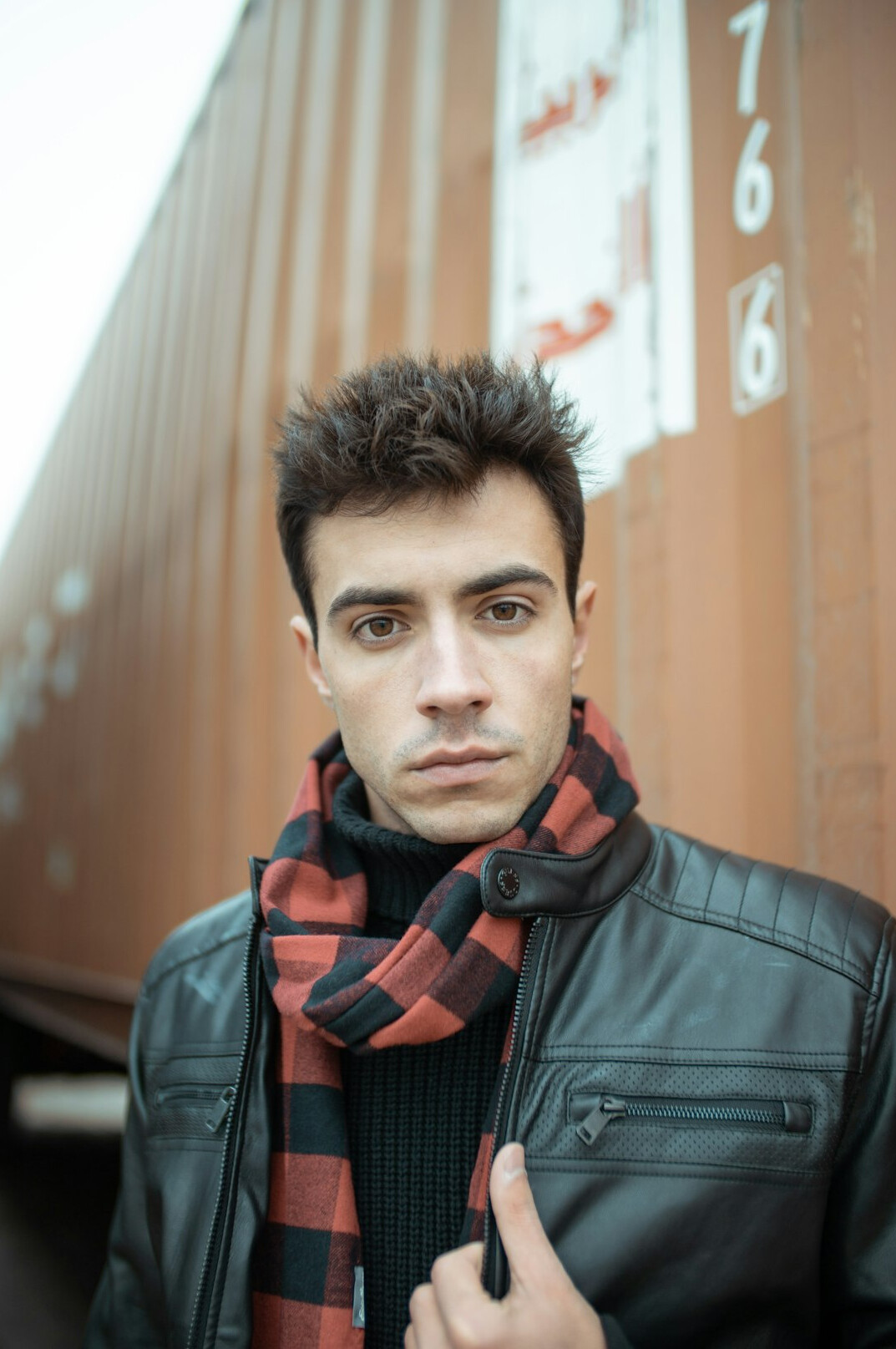 Portrait of a Latino man fiction writer in his thirties wearing a scarf